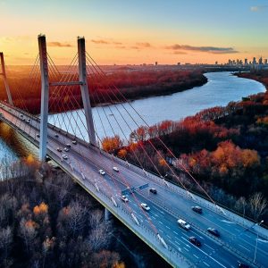 Papier Peint Beautiful Panoramic Aerial Drone View To Cable-Stayed Siekierkowski Bridge Over The Vistula River And Warsaw City Skyscrapers, Poland In Gold Red Autumn Colors In November Evening At Sunset – Image 1